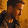 A man with short hair and a trimmed beard is wearing a thick, fur-collared coat and looking to the right in warm, golden lighting. The background is softly blurred.